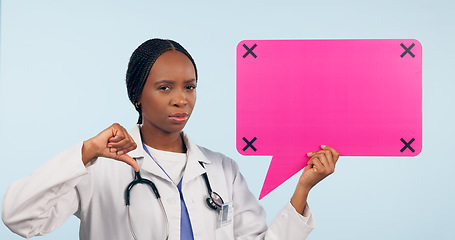 Image showing Black woman, doctor and thumbs down with speech bubble for social media or bad review against a studio background. Portrait of African female person, surgeon or nurse showing icon, no sign or mockup