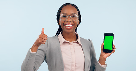 Image showing Business woman, thumbs up and green screen phone with portrait for review, choice or app by blue background. African entrepreneur, yes and studio for smartphone mockup, chromakey or tracking markers