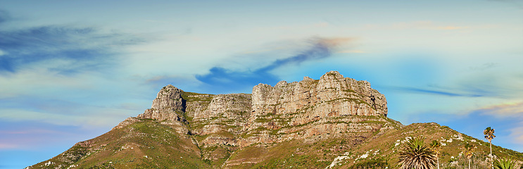 Image showing Low angle view of a mountain peak against a stunning colorful sky in South Africa. Scenic panorama landscape of a remote hiking location near Cape Town. Travel and explore nature through adventure