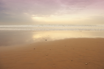 Image showing Seascape and landscape of a golden sunset on the west coast of Jutland in Loekken, Denmark. Beautiful cloudscape on an empty beach at dusk. Clouds over the ocean and sea in the evening with copyspace