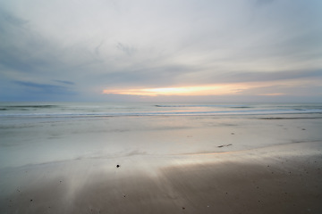 Image showing Seascape and landscape of a blue sunset on the west coast of Jutland in Loekken, Denmark. Beautiful cloudscape on an empty beach at dusk. Clouds over the ocean and sea in the evening with copyspace
