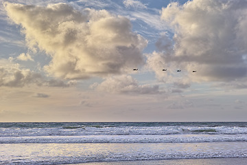 Image showing Seascape and landscape of a blue sunset on the west coast of Jutland in Loekken, Denmark. Beautiful cloudscape on an empty beach at dusk. Clouds over the ocean and sea at night with copyspace