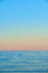 Image showing Seascape and landscape of a golden sunset on the west coast of Jutland in Loekken, Denmark. Beautiful view on an empty beach at dusk. Sun rising over the ocean and sea in the morning with copyspace