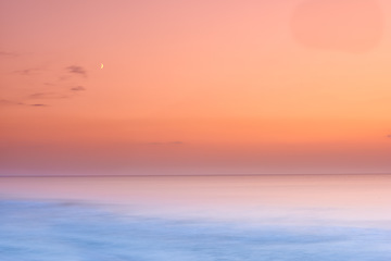 Image showing Seascape and landscape of a golden sunset on the west coast of Jutland in Loekken, Denmark. Beautiful cloudscape on an empty beach at dusk. Clouds over the ocean and sea in the evening with copyspace