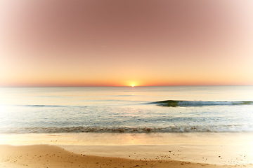 Image showing Seascape and landscape of a golden sunset on the west coast of Jutland in Loekken, Denmark. Beautiful cloudscape on an empty beach at dusk. Clouds over the ocean and sea in the evening with copyspace