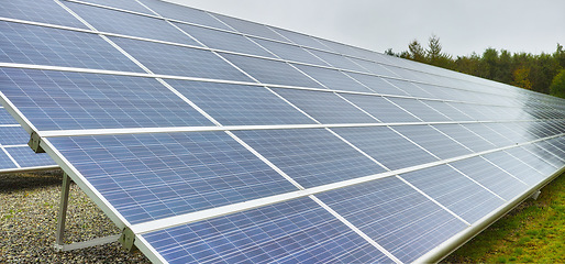 Image showing Sun energy. Solar power station in Denmark. Photovoltaic solar cell panels as renewable energy source. Blue solar panels generating electricity in solar power station, alternative energy from nature.