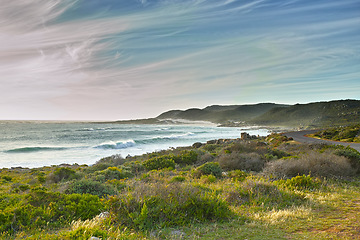 Image showing A rocky coastline in the Western Cape, South Africa on a hot summer day. Sky and beach, a perfect getaway filled with self care resorts and wellness outdoor activities with tropical weather