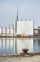 Image showing A factory seen from across a body of water, industrial industry adding to air pollution, contamination and environmental pollution, deathly toxic for the planet and global state of wellbeing