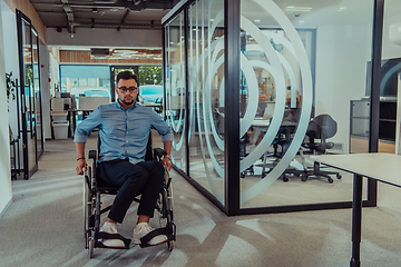 Image showing In a large modern corporation, a determined businessman in a wheelchair navigates through a hallway, embodying empowerment and inclusivity in the corporate world.