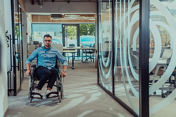 Image showing In a large modern corporation, a determined businessman in a wheelchair navigates through a hallway, embodying empowerment and inclusivity in the corporate world.