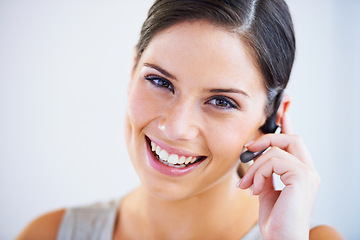 Image showing Call center, woman and portrait in studio for communication, telecom questions and customer service support on white background. Face of happy telemarketing consultant with microphone for CRM contact