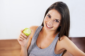 Image showing Portrait, smile and apple with a woman eating fruit for health, diet or nutrition in the kitchen of her home. Food, nutritionist and a happy young model in a house for organic wellness or weight loss