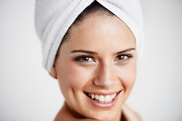 Image showing Smile, beauty and woman with towel in a studio for health, wellness and natural face routine. Happy, skincare and portrait of young female model with facial dermatology treatment by gray background.