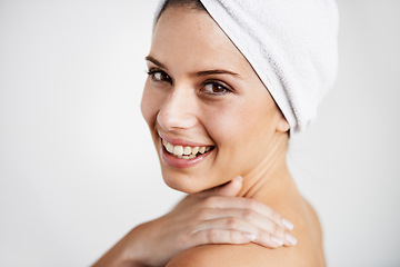 Image showing Smile, cosmetic and woman with towel in a studio for health, wellness and natural face routine. Happy, beauty and portrait of young female model with facial dermatology treatment by gray background.