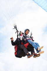 Image showing People, paragliding and smile in sky, together or extreme sport with freedom for fitness. Coach, partnership and person on adventure, helmet or fearless with backpack, parachute or portrait in clouds