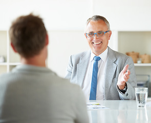 Image showing Meeting, people and happy mature lawyer with advice in office for legal consulting and feedback for client, Businessman, talking and professional attorney in law firm with discussion of contract