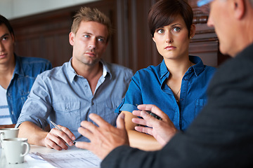 Image showing Business meeting, team and mentor or serious for communication, strategy or brainstorming in office. Employees, men and woman with partnership, collaboration or documents at workplace or company