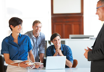 Image showing Business meeting, team and mentor with smile for planning, strategy or brainstorming in office. Employees, men and woman with partnership, collaboration or technology and discussion at workplace
