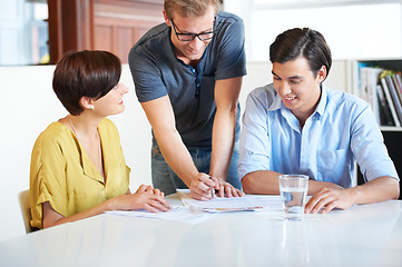 Image showing Business meeting, team and paperwork for planning, research or brainstorming in office with communication. Employees, men and woman with partnership, collaboration or creative and discussion at work