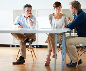 Image showing Man, tired and bored in meeting at office, workplace or people planning with notes and documents. Team, discussion and manager with fatigue, burnout or exhausted at work with staff in conference room