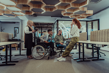 Image showing Young group of business people brainstorming together in a startup space, discussing business projects, investments, and solving challenges.