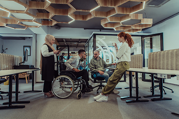 Image showing Young group of business people brainstorming together in a startup space, discussing business projects, investments, and solving challenges.