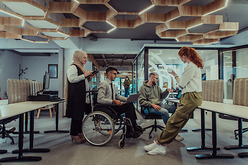 Image showing Young group of business people brainstorming together in a startup space, discussing business projects, investments, and solving challenges.