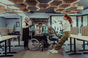 Image showing Young group of business people brainstorming together in a startup space, discussing business projects, investments, and solving challenges.