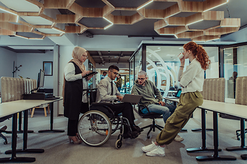 Image showing Young group of business people brainstorming together in a startup space, discussing business projects, investments, and solving challenges.