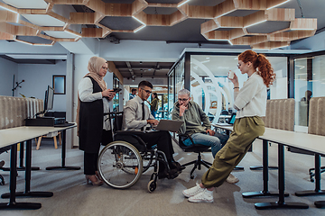 Image showing Young group of business people brainstorming together in a startup space, discussing business projects, investments, and solving challenges.