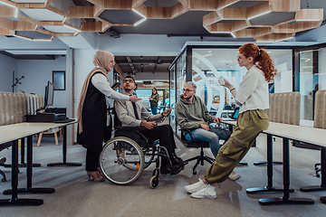 Image showing Young group of business people brainstorming together in a startup space, discussing business projects, investments, and solving challenges.