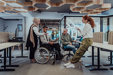 Image showing Young group of business people brainstorming together in a startup space, discussing business projects, investments, and solving challenges.