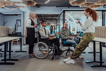 Image showing Young group of business people brainstorming together in a startup space, discussing business projects, investments, and solving challenges.