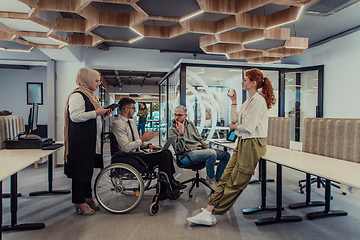 Image showing Young group of business people brainstorming together in a startup space, discussing business projects, investments, and solving challenges.