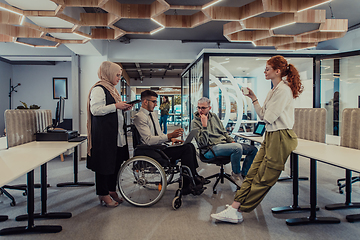 Image showing Young group of business people brainstorming together in a startup space, discussing business projects, investments, and solving challenges.