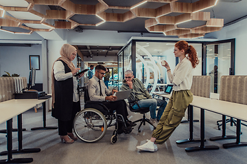 Image showing Young group of business people brainstorming together in a startup space, discussing business projects, investments, and solving challenges.