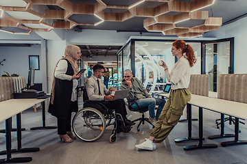 Image showing Young group of business people brainstorming together in a startup space, discussing business projects, investments, and solving challenges.