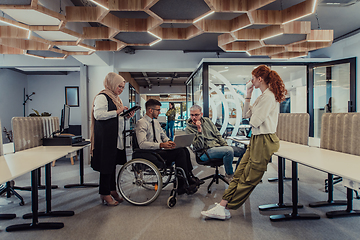 Image showing Young group of business people brainstorming together in a startup space, discussing business projects, investments, and solving challenges.