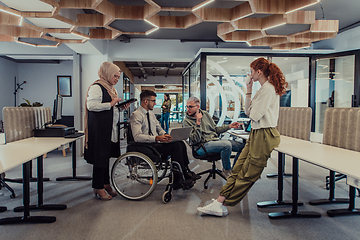 Image showing Young group of business people brainstorming together in a startup space, discussing business projects, investments, and solving challenges.