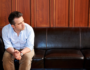 Image showing Man, thinking and stress on sofa in waiting room for interview, recruitment or loss of job. Businessman, anxiety and sitting on couch with fear for unemployment, failure or problem in work mockup