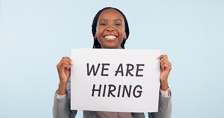 Image showing Business woman, hiring poster and studio portrait with smile for recruitment, talent or search by blue background. Happy African manager, human resources and sign for offer, employee or opportunity