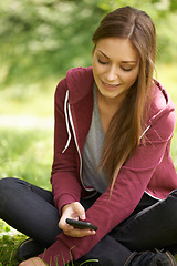 Image showing Woman in park with phone, social media at university, internet connection and website for school. Relax, smartphone and college student on grass in campus garden for research, mobile app and smile.