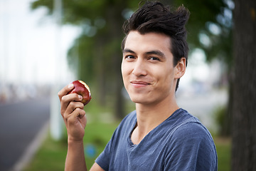 Image showing Man, smile and eating an apple, health and wellness in portrait, nutrition and vitamins for vegan. Happy male person, fruit and organic or natural, breakfast and diet in outdoors, fresh and digestion