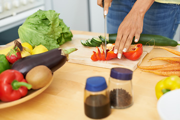 Image showing Woman, hands and cutting tomato in kitchen on wooden board for healthy diet or vegetarian meal at home. Closeup of female person slicing natural organic red vegetable for salad preparation at house