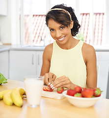 Image showing Portrait, strawberry and fruit salad with a woman in the kitchen of her home for health, diet or nutrition. Smile, food and weight loss with a young person in her apartment for meal preparation