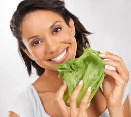 Image showing Happy woman, portrait and lettuce for healthy diet, vegetables or snack against a studio background. Face of female person smile with green leaves for natural nutrition, fiber or health and wellness