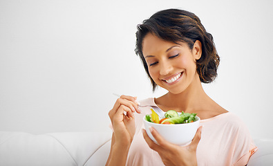 Image showing Happy woman, bowl and eating salad for healthy diet, natural nutrition or wellness on living room sofa at home. Female person, vegan or nutritionist smile for vegetarian meal, fiber or vitamin snack