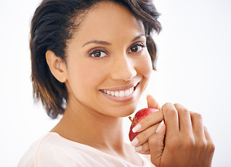 Image showing Happy, apple and portrait of woman in a studio for wellness, nutrition and organic diet. Smile, vitamins and young female person from Mexico eating fruit for healthy vegan snack by white background.