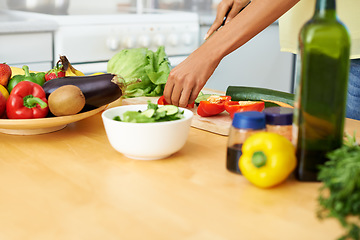 Image showing Hands, food and salad with a person in the kitchen of a home closeup for health, diet or nutrition. Cooking, bowl and ingredients for a vegetarian meal with an adult in an apartment for dinner