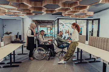 Image showing Young group of business people brainstorming together in a startup space, discussing business projects, investments, and solving challenges.